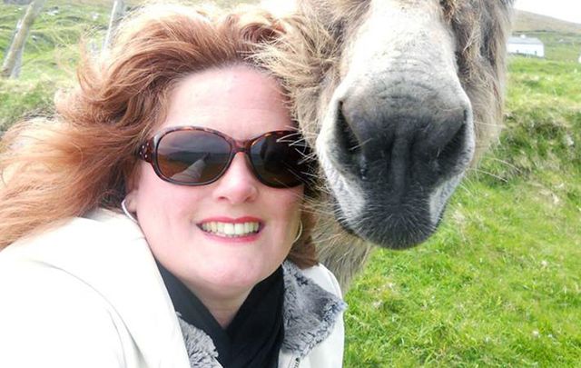 Kathleen Maloney (and a donkey) on a recent trip to Ireland. 