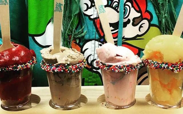 Flight of four sprinkles-rimmed shot glasses withTipsy Scoop's alcohol-infused ice cream.