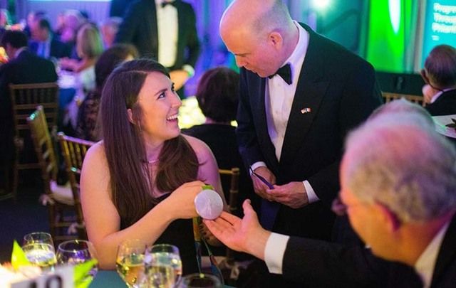Ireland Funds Gala: Ireland\'s Silver Olympic Medalist Annalise Murphy, left, shows medal to Jim Rooney, son of the late Ambassador Dan Rooney, center, and David Donoghue, Ireland\'s ambassador to the United Nations.