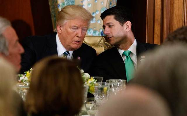 Speaker of the House Paul Ryan speaks to President Donald Trump.