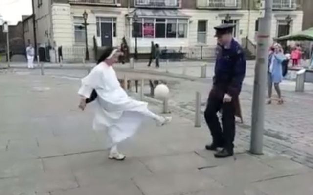 Look at that kick! Nun and cop play soccer. 