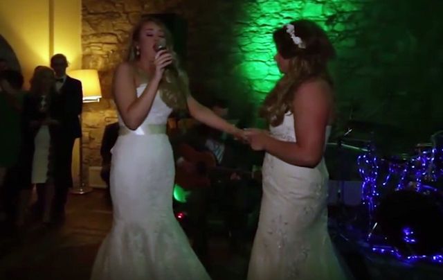 Heather sings to her new wife, Lauren, on the dance floor before their first dance. 