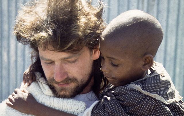 A Young Bono with a child he met on his first trip to Ethiopia in 1985.