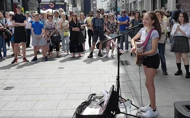 Twelve-year-old performer Allie Sherlock draws a crowd on Dublin\'s Grafton Street.