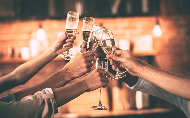 A group celebrate with champagne. 