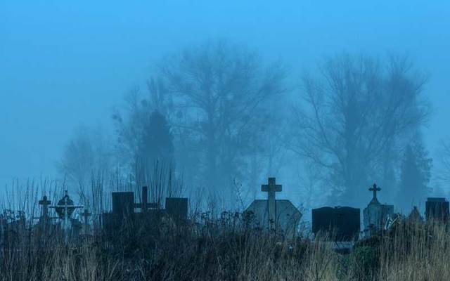 A graveyard at dusk.