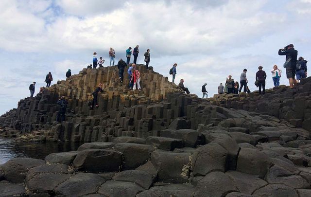 Tourists exploring the Giant\'s Causeway, in County Antrim.