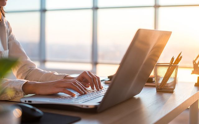 A blogger on a computer. 