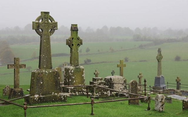 Celtic High Cross among the headstones in the cemetery at the Rock of Cashel, Co Tipperary.