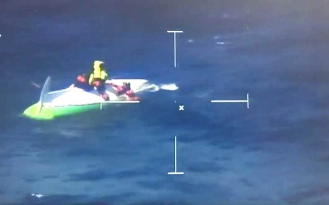 Snapshot of footage of the rescue of two men attempting to row across the Atlantic.