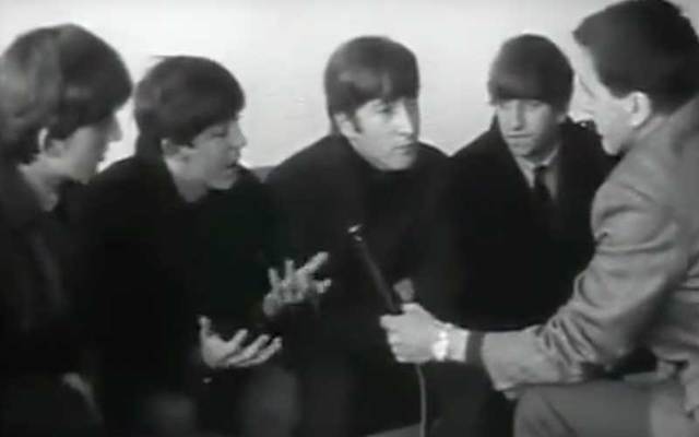 In this snapshot, The Beatles are interviewed by RTE\'s Frank Hall in Dublin.