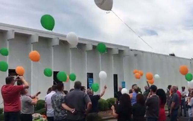 Jason Corbett\'s former co-workers hold a memorial commemoration for the second anniversary of his death with balloons the color of the Irish flag. 