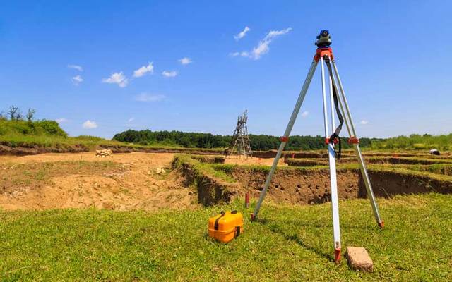 Stock photo of surveying measuring equipment in a field.