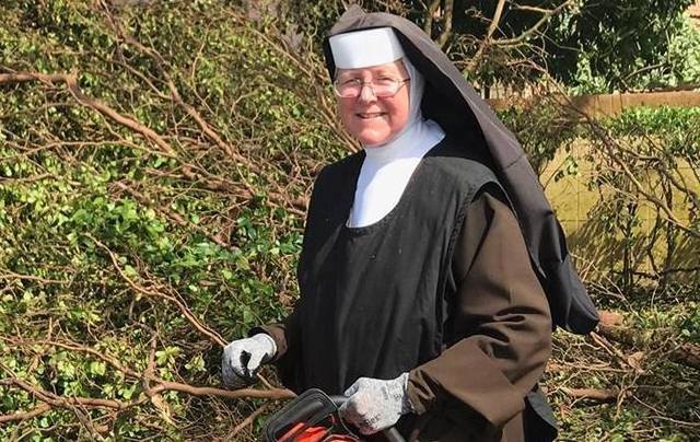 Sister Margaret Ann removes debris obstructing a road after Hurricane Irma