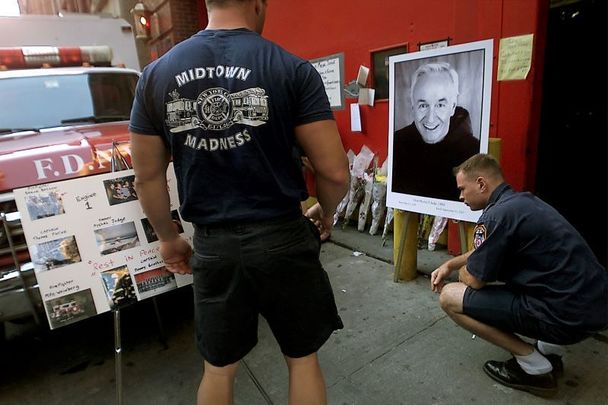 September 13, 2001: Firefighters pause at a makeshift memorial for Father Mychal Judge.