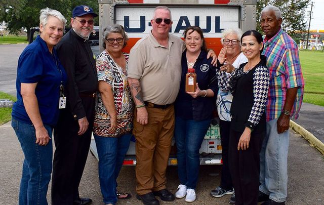 Ed Shevlin (center) and Leslie Mahoney (third from right) with locals in Port Arthur who accepted their donations.