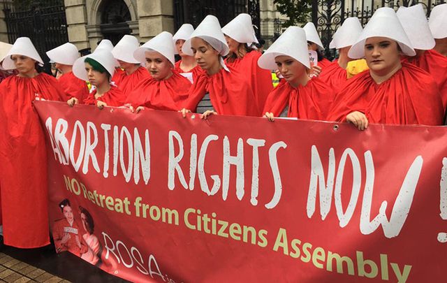 Protesting the eighth amendment of the Irish constitution which completely outlaws abortion, Irish women wore the red cloaks from the popular TV show The Handmaids Tale as they gathered outside Irish government buildings on Wednesday. 