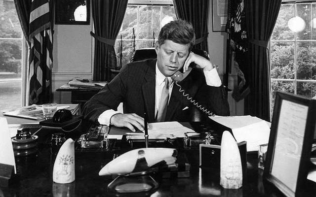 President John F Kennedy on the phone in the Oval Office.