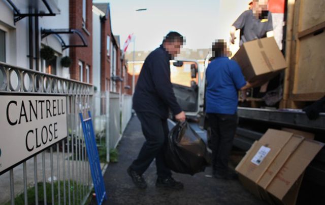 A Catholic family moves possessions from their home in Cantrell Close in Belfast. The faces have been obscured in the photo for the family’s protection.