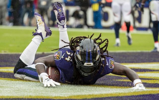 Alex Collins #34 of the Baltimore Ravens scores a touchdown against the Denver Broncos during the first half at M&T Bank Stadium on September 23, 2018, in Baltimore, Maryland.