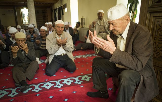 Men at prayer in a mosque. 