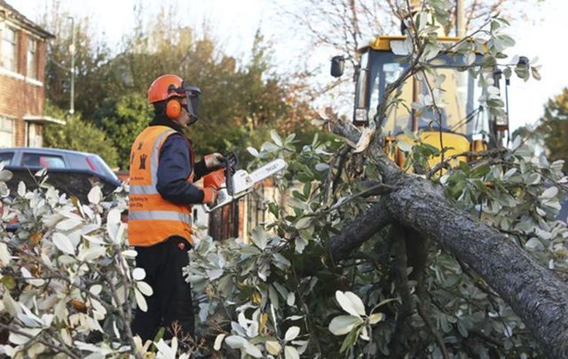 Workers clear the destruction caused by Storm Ophelia. 