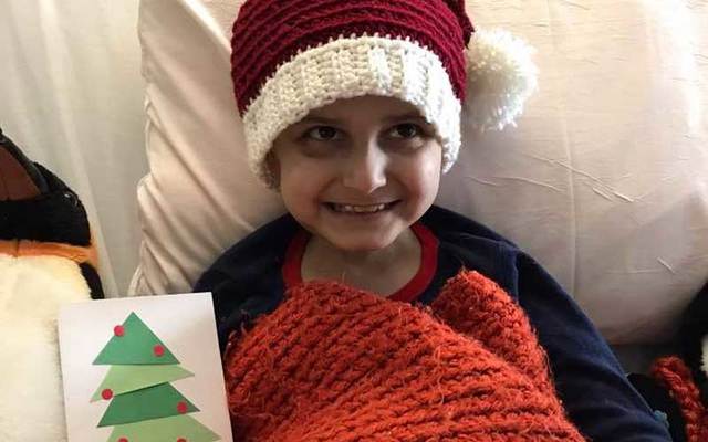 Jacob Thompson, 9, smiles after receiving a new Christmas card.