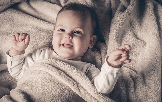 A baby girl laughing.