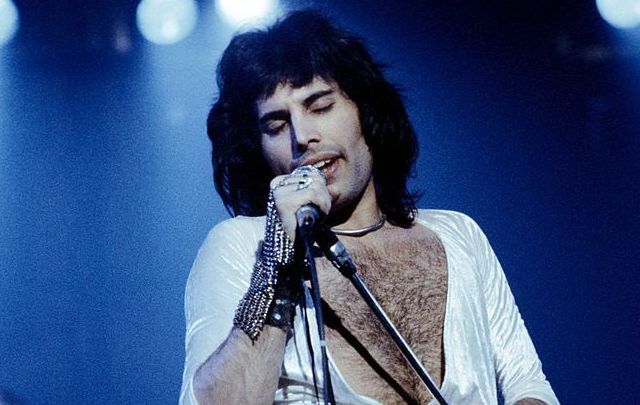 Freddie Mercury (1946 - 1991), lead singer of 70s hard rock quartet Queen, performing live on stage.