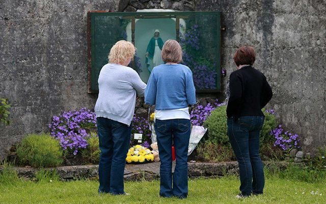 Local women pay their respects at a grotto erected on the site of the mass grave at Tuam, County Galway.