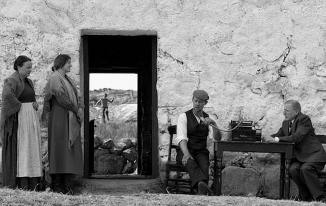 A scene from Song of Granite in which a young Joe Heaney watches as his father sings for a folklore collector. 