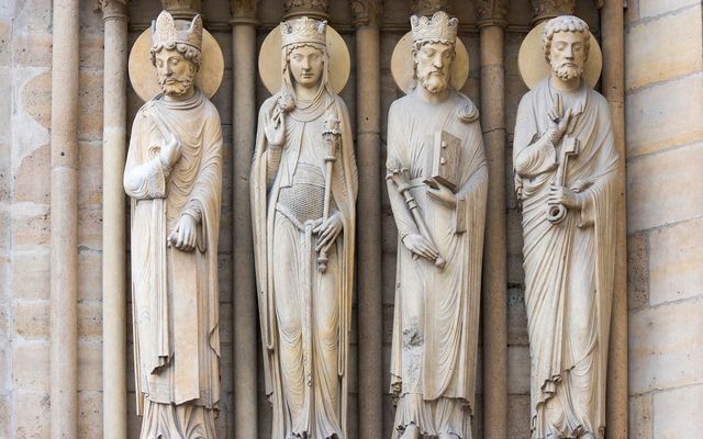 An Australian school placed a veil over a new statue of a saint offering a kneeling child a loaf of bread after it was criticized by social media users.