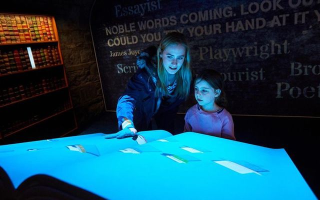 Visitors enjoying the digital library room at EPIC The Irish Emigration Museum in Dublin.