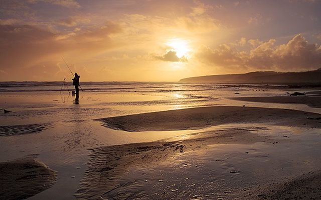 The sun rising over Ballybrannigan Beach in Co. Cork. 