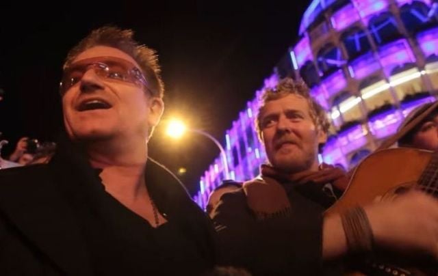 Bono and Glen Hansard busking on Christmas Eve 2012 in Dublin. 