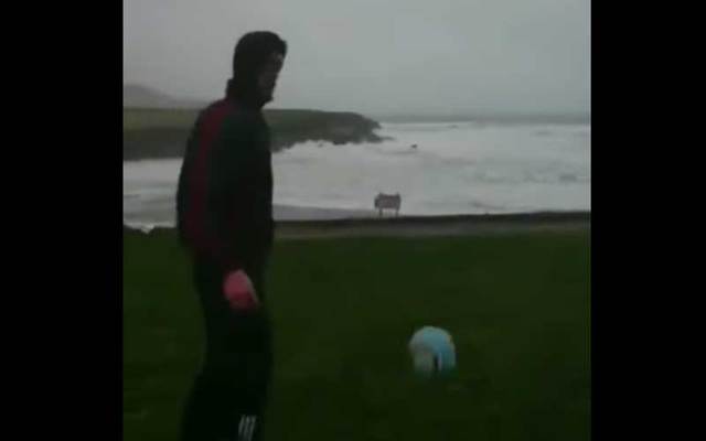 Irish football player Eanna O’Connor kicks a ball out into the weather and the strong winds send it right back to him.