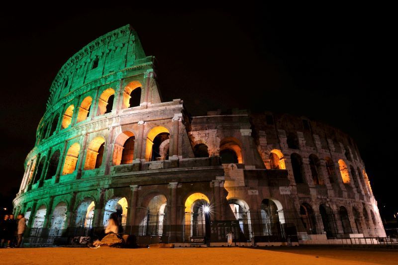 How are the landmarks that light up green for St. Patrick's Day linked to Ireland?