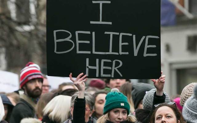 Woman holds up #IBelieveHer sign during a rally in Dublin on Thursday protesting the verdict of the Belfast rugby rape case.