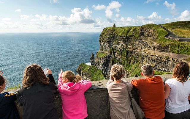 Tourists taking in the breath-taking views at the Cliffs of Moher, County Clare.