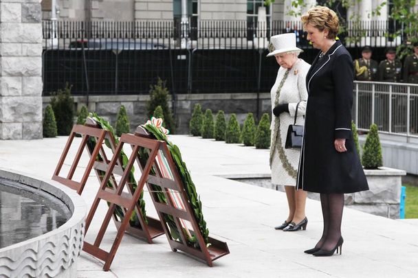 Queen Elizabeth II with then-President Mary McAleese paying their respects at Dublin\'s Garden of Remembrance, a place dedicated to the memory of \"all those who gave their lives in the cause of Irish Freedom\".