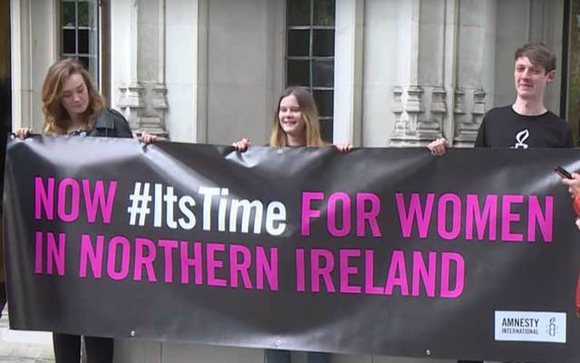 Abortion protesters stand with sign \"Now #ItsTime for Women in Northern Ireland.\"