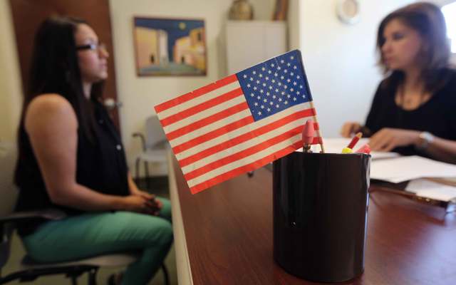 Colombian immigrant Paola Parra (L) takes her oral citizenship test at the U.S. Citizenship and Immigration Services (USCIS) Queens office on May 30, 2013, in the Long Island City neighborhood of the Queens borough of New York City.