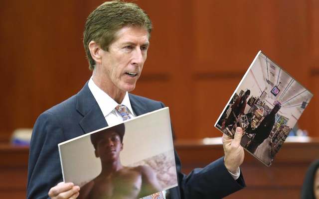 Mark O\'Mara displays photos of Trayvon Martin to the jury during closing arguments in Zimmerman\'s murder trial July 12, 2013, in Sanford, Florida.\n