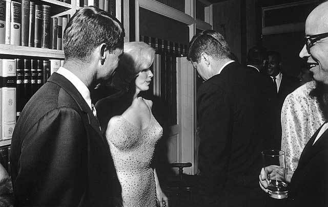 Cecil Stoughton\'s famous photograph of Marilyn Monroe, John F. Kennedy, and Robert F. Kennedy.