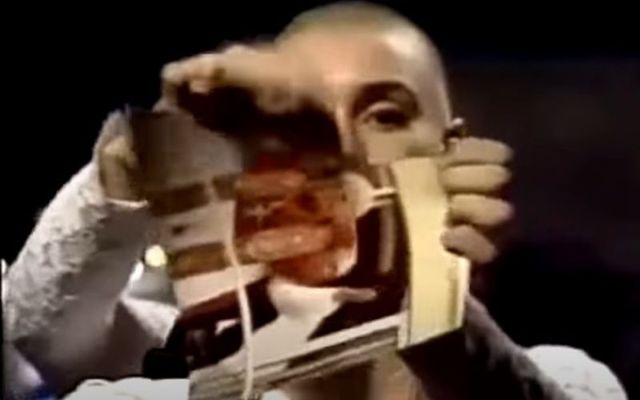Irish singer Sinéad O\'Connor rips up a photo of Pope John Paul II while performing on Saturday Night Live (SNL).