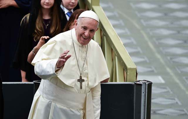 Pope Francis waves as he arrives for his weekly general audience in Paul VI hall on August 22, 2018, at The Vatican.