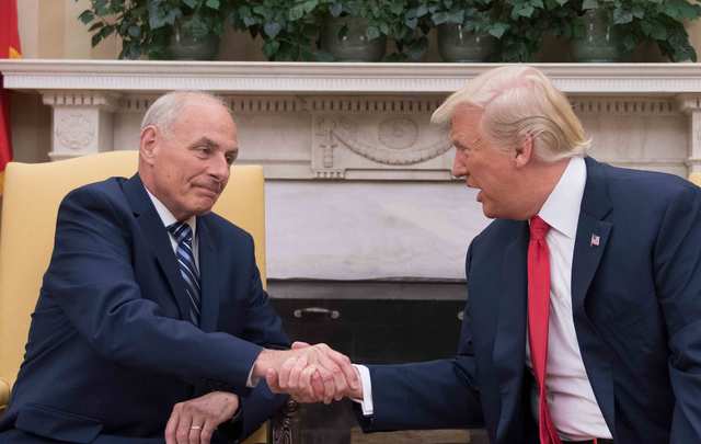 US President Donald Trump (R) shakes hands with newly sworn-in White House Chief of Staff John Kelly at the White House in Washington, DC, on July 31, 2017. 