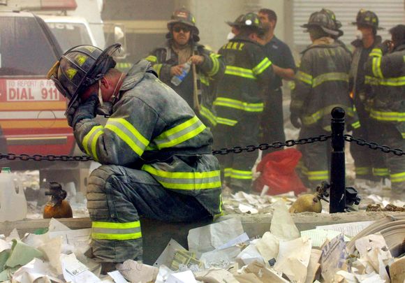 New York City fire department members take a rest at Ground Zero after 9/11.