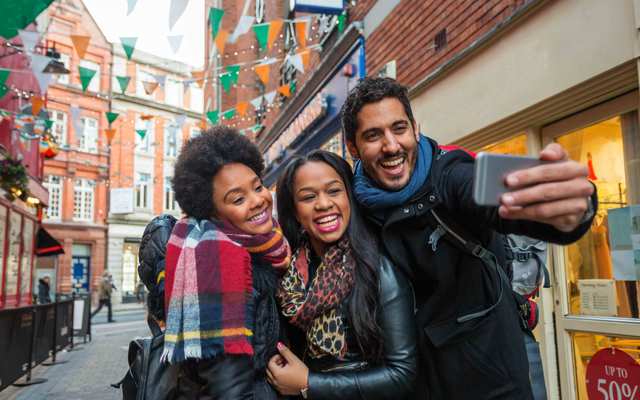 Tourists taking selfies while on vacation in Dublin, Ireland. \n