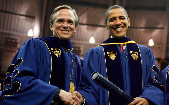 U.S. President Barack Obama shakes hands after receiving an honorary law degree from the University of Notre Dame by University President Rev. John I. Jenkins (L) during the 164th commencement ceremonies of the University of Notre Dame in the Joyce Center on May 17, 2009, in South Bend, Indiana.